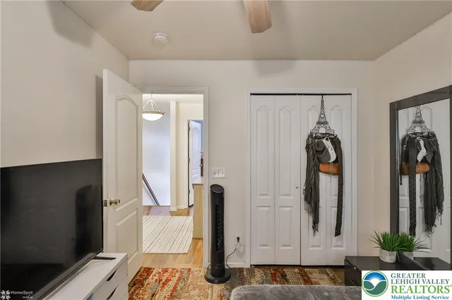 a bedroom with a bed and a mirror on dresser