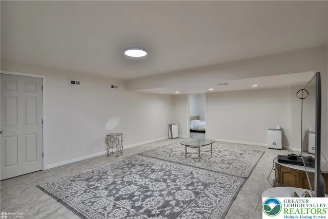 a view of a livingroom with furniture and a flat screen tv