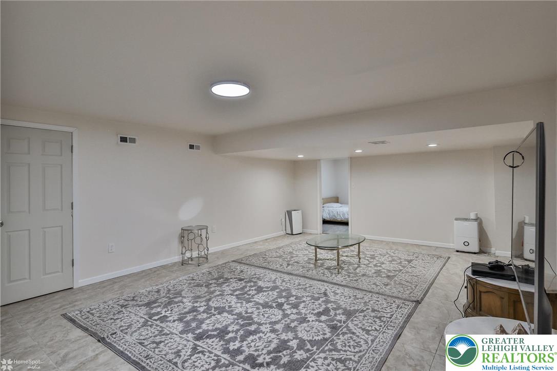 204 Ridings Circle Macungie, PA 18062 - Photo 42 of 53 a living room with a rug and a couch