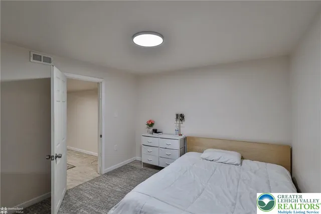 a bedroom with a bed and a lamp