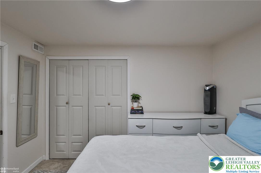 204 Ridings Circle Macungie, PA 18062 - Photo 48 of 53 a bedroom with a bed and a lamp