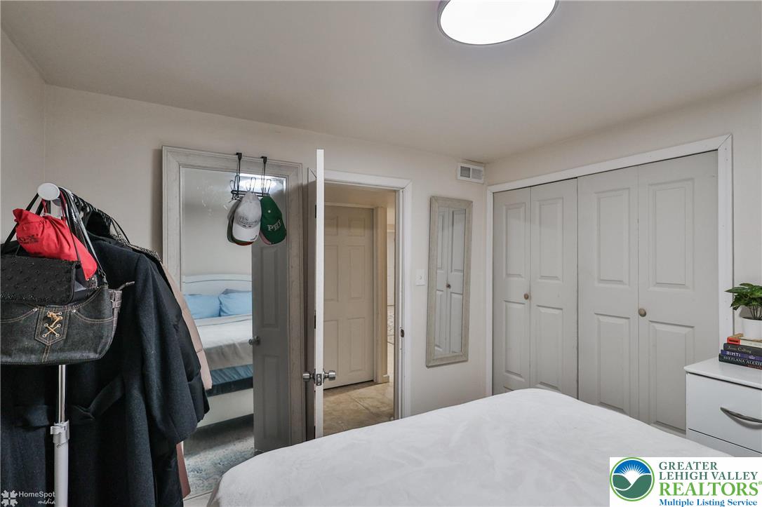 204 Ridings Circle Macungie, PA 18062 - Photo 49 of 53 a bedroom with a bed and a chandelier