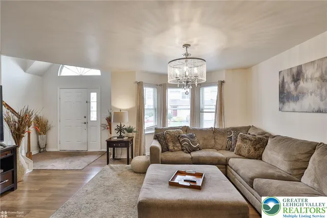 a living room with furniture and a chandelier