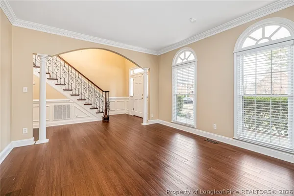 a view of an entryway with wooden floor door and windows