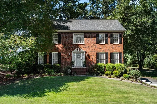 a front view of a house with a yard and porch