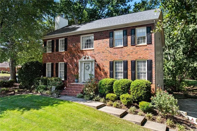 a front view of a house with a yard and porch