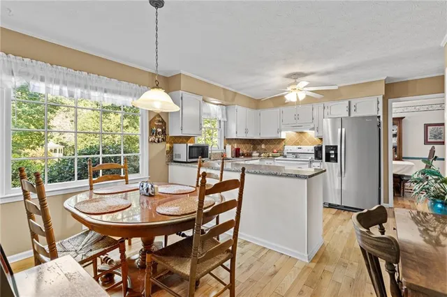 a kitchen with a table and chairs