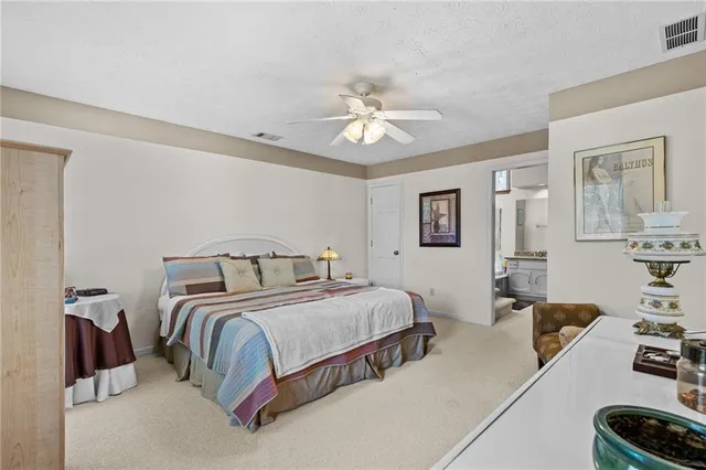 a bedroom with a bed mirror and window