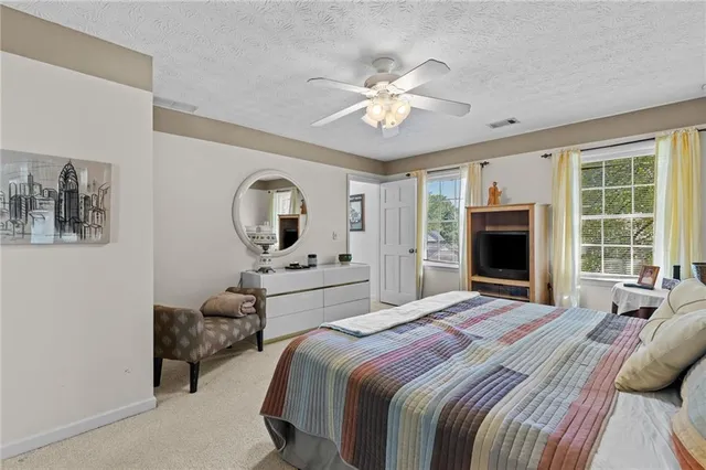 a bathroom with double vanity sinks a large mirror and a bathtub