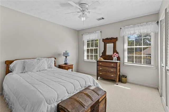 a bedroom with a large bed and a chandelier