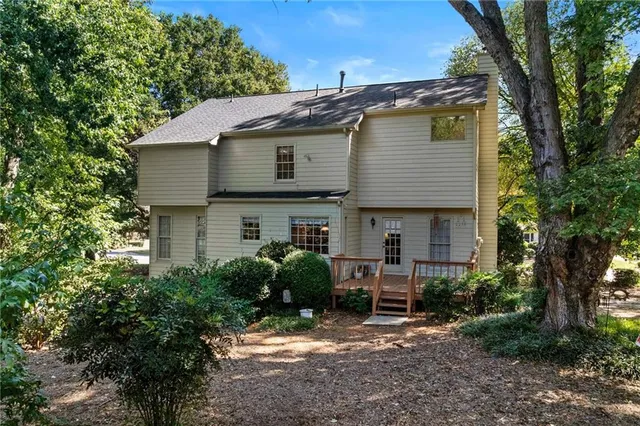 a view of a yard with plants and trees