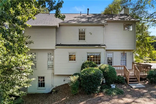 a view of a house with backyard and sitting area