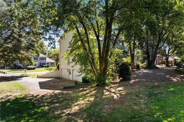 a view of a backyard with large trees