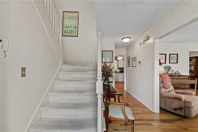 a view of a livingroom with wooden floor and furniture