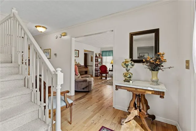 a view of a livingroom with furniture and hardwood floor