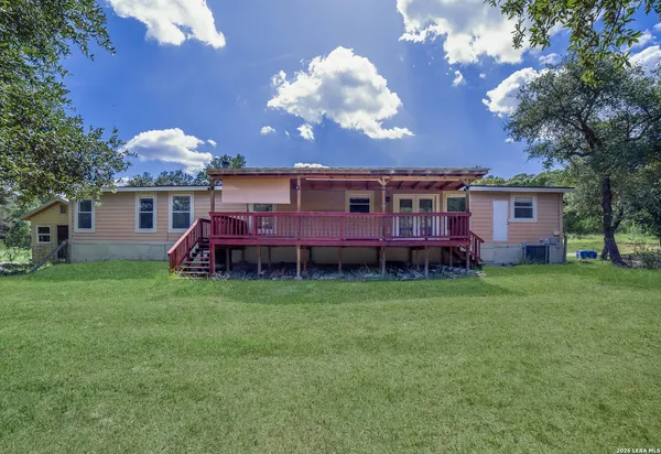 a view of a house with backyard and porch