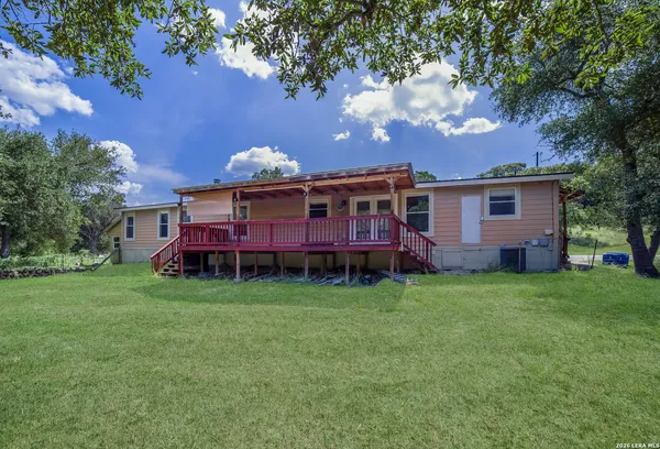 a view of a house with a backyard