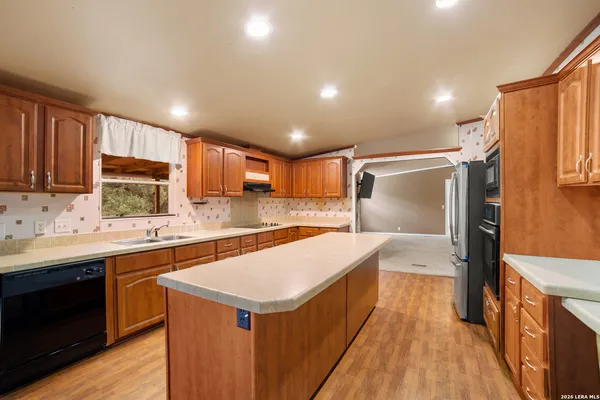 a kitchen with a sink stove and refrigerator