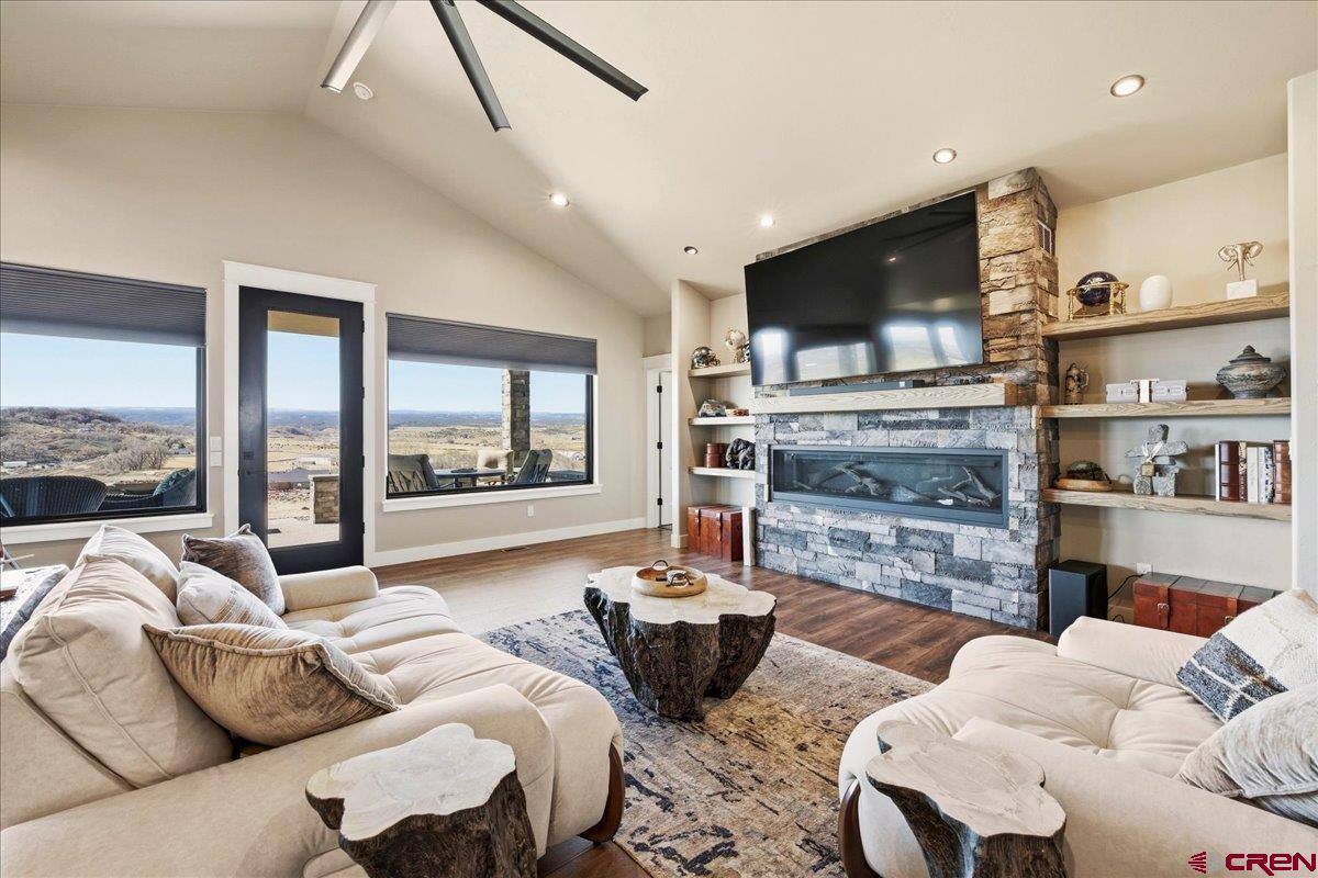 11266 5880 Road Montrose, CO 81403 - Photo 12 of 43 a living room with furniture wooden floor and a large window