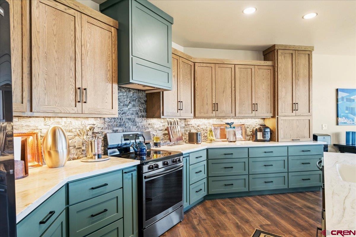 11266 5880 Road Montrose, CO 81403 - Photo 16 of 43 a kitchen with stainless steel appliances granite countertop a sink a stove and cabinets