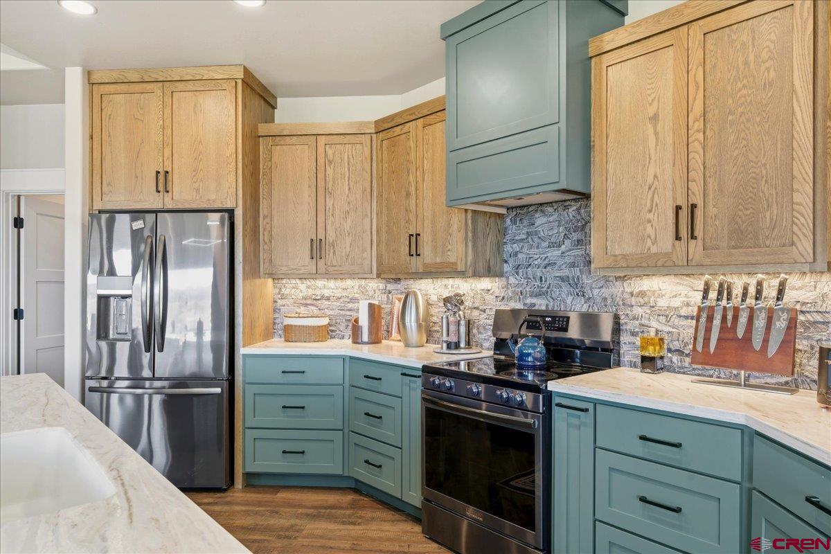11266 5880 Road Montrose, CO 81403 - Photo 17 of 43 a kitchen with stainless steel appliances granite countertop a refrigerator sink and cabinets