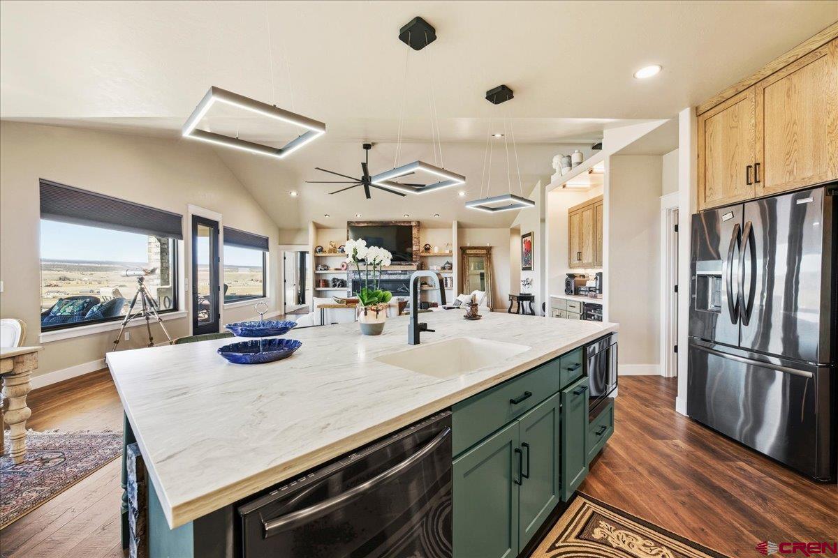 11266 5880 Road Montrose, CO 81403 - Photo 18 of 43 a kitchen with stainless steel appliances granite countertop a sink a stove and a refrigerator