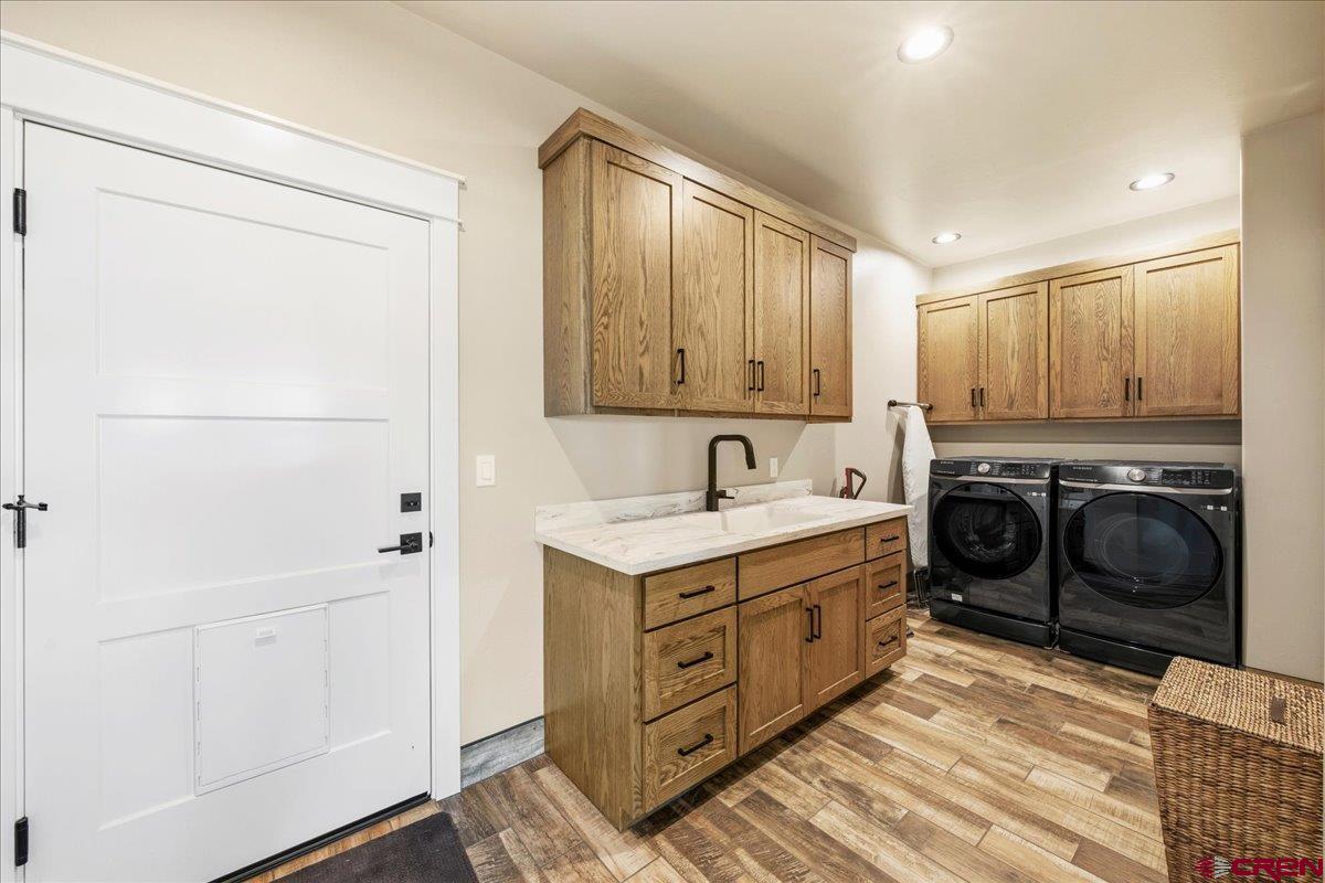 11266 5880 Road Montrose, CO 81403 - Photo 22 of 43 a utility room with cabinets washer and dryer