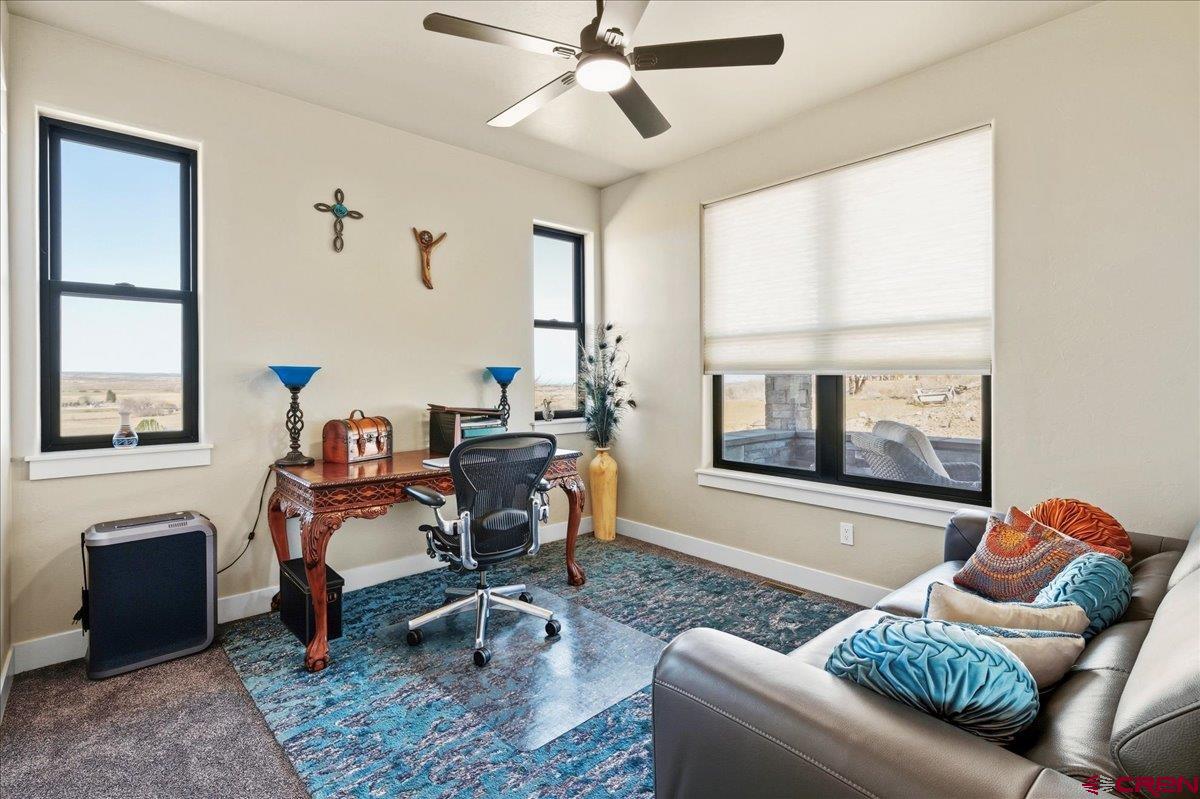 11266 5880 Road Montrose, CO 81403 - Photo 24 of 43 a living room with furniture rug and window