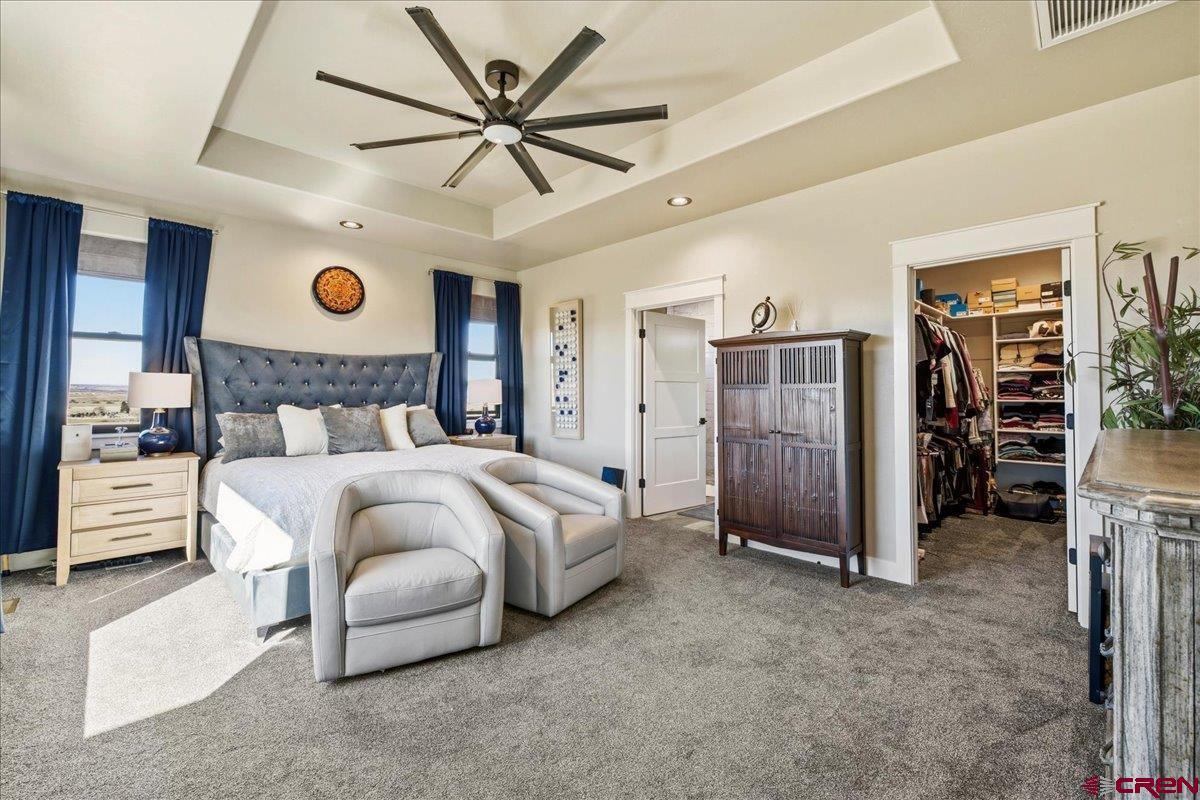 11266 5880 Road Montrose, CO 81403 - Photo 30 of 43 a bedroom with a large bed and a ceiling fan