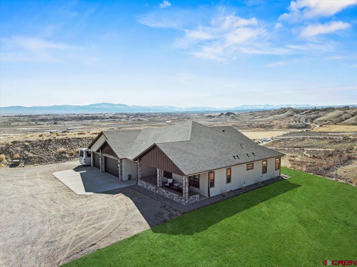 11266 5880 Road Montrose, CO 81403 - Photo 4 of 43 an aerial view of a house with roof deck and city view