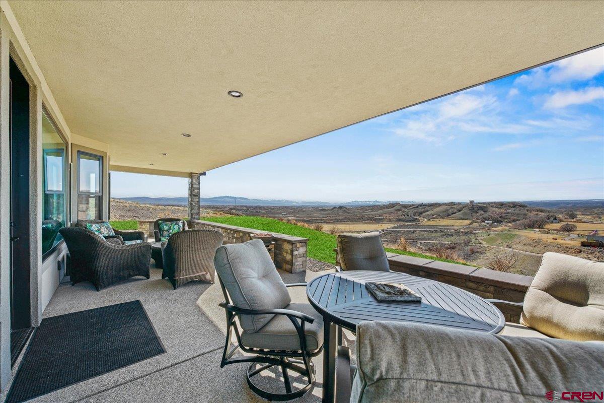 11266 5880 Road Montrose, CO 81403 - Photo 8 of 43 a balcony with furniture and city view