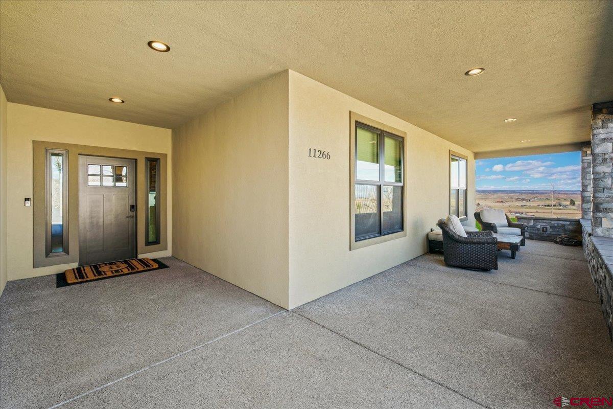 11266 5880 Road Montrose, CO 81403 - Photo 9 of 43 a living room with furniture gym equipment and a large window
