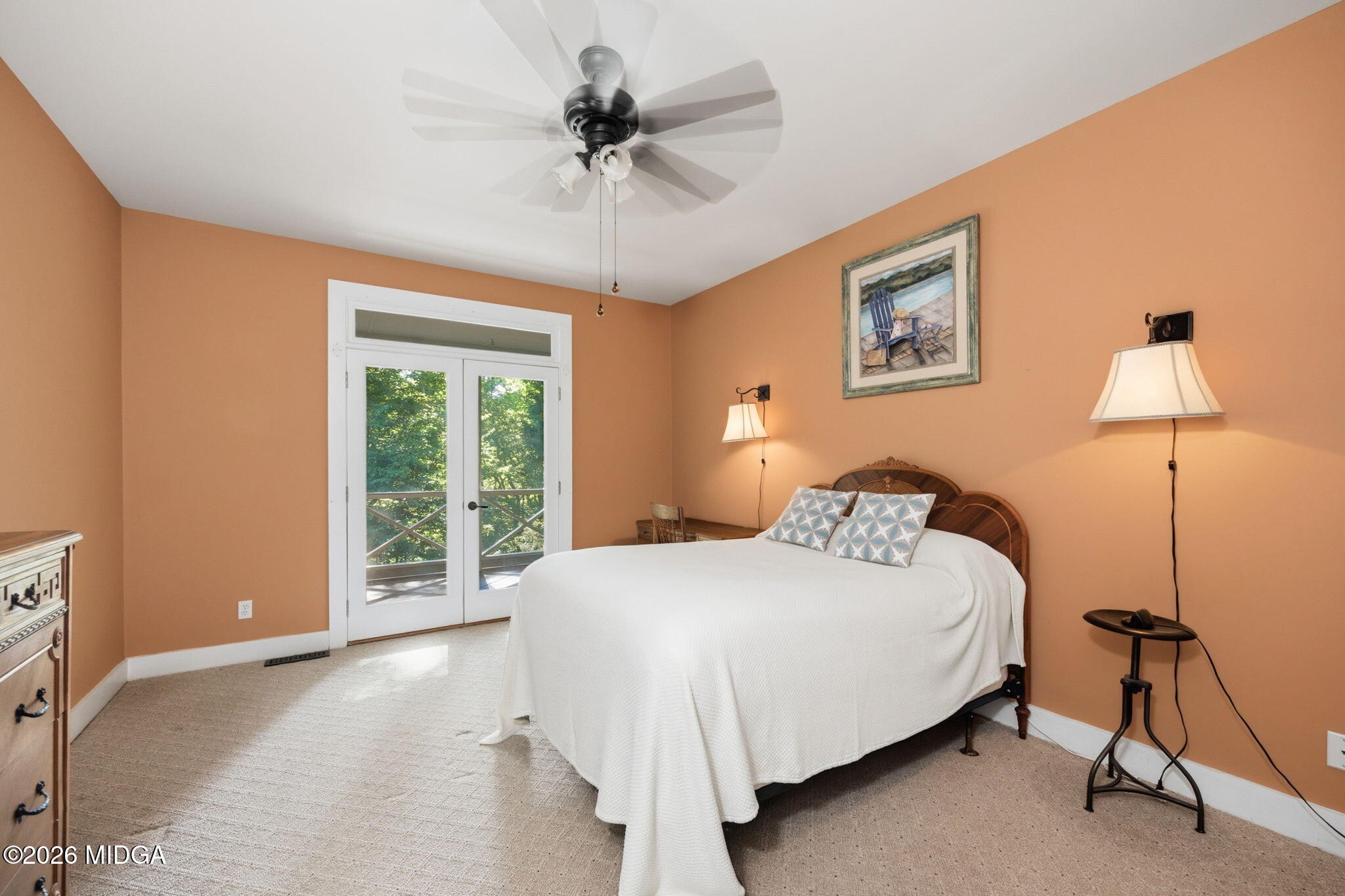 4686 Johnstonville Road Forsyth, GA 31029 - Photo 15 of 34 a bedroom with a bed and a chandelier