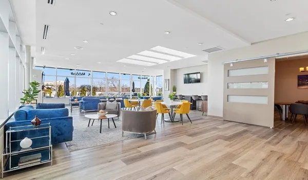 a living room with lots of furniture and a wooden floor