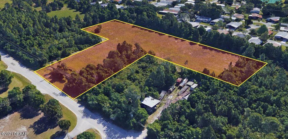 825 Hull Road Ormond Beach, FL 32174 - Photo 2 of 32 an aerial view of a house with a yard and outdoor seating