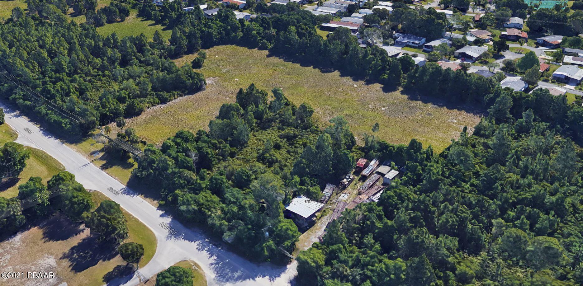 825 Hull Road Ormond Beach, FL 32174 - Photo 24 of 32 an aerial view of a house with a yard and lake view
