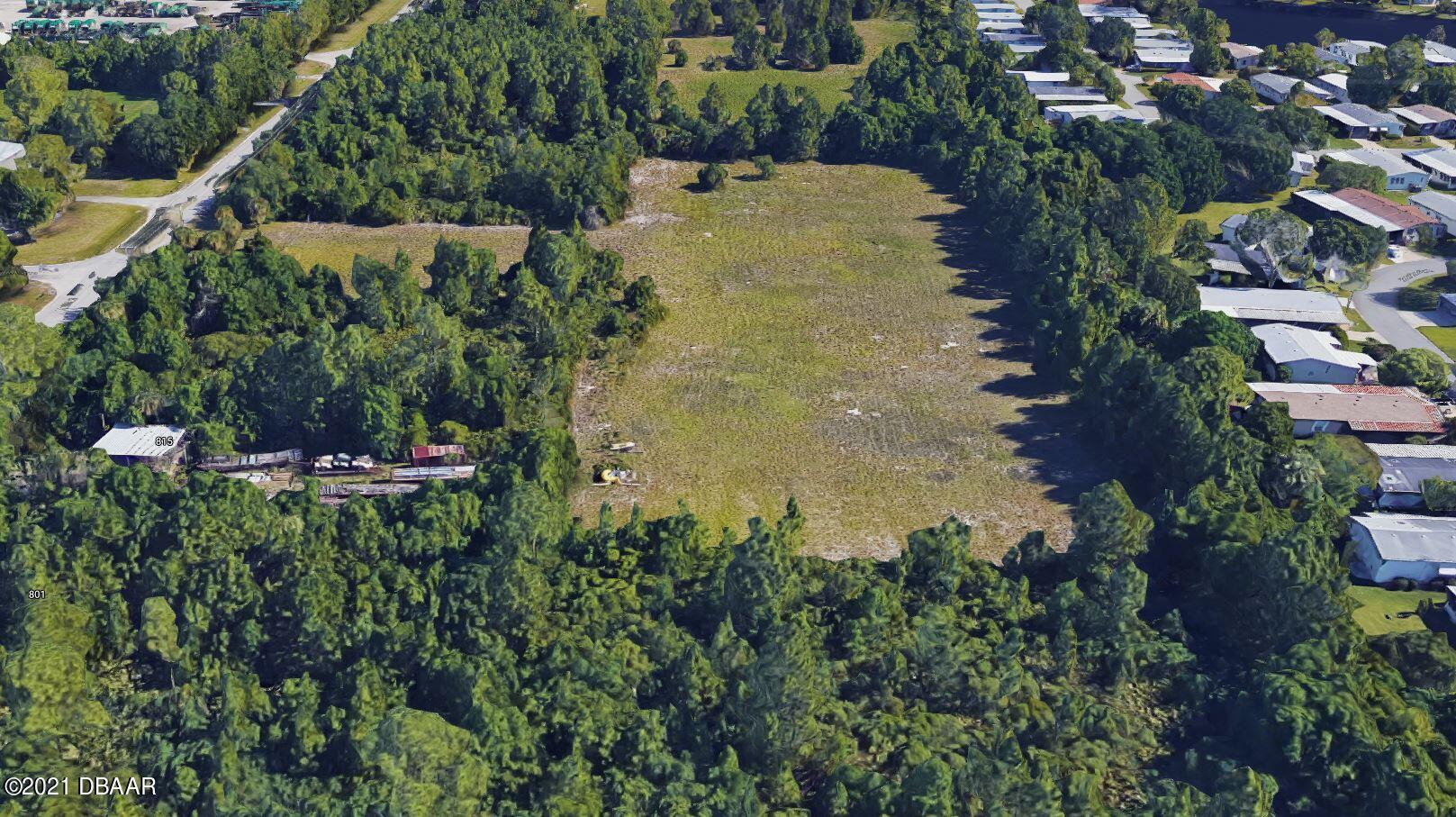 825 Hull Road Ormond Beach, FL 32174 - Photo 25 of 32 an aerial view of residential house with outdoor space and trees all around