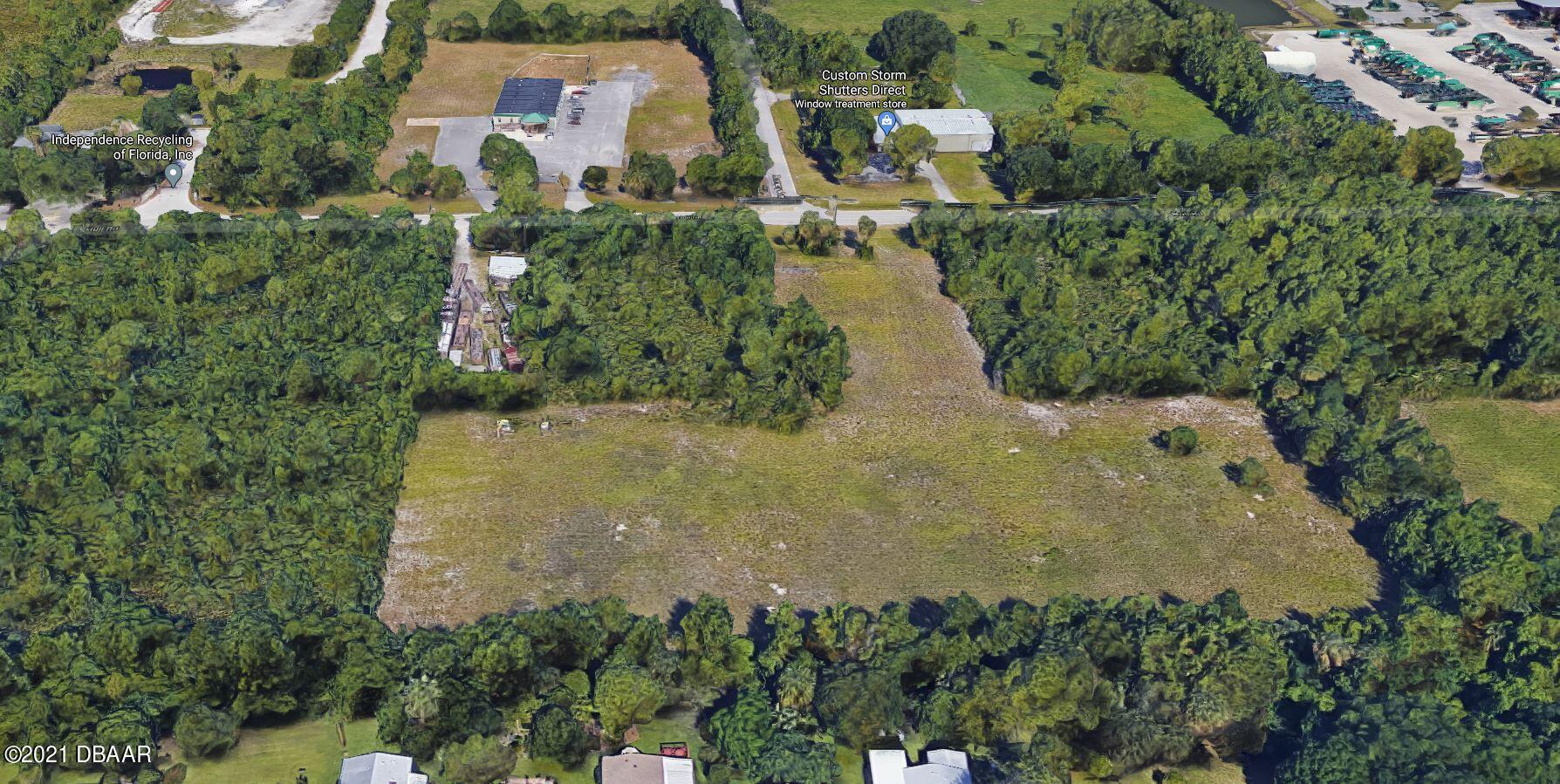 825 Hull Road Ormond Beach, FL 32174 - Photo 27 of 32 an aerial view of a house with a yard