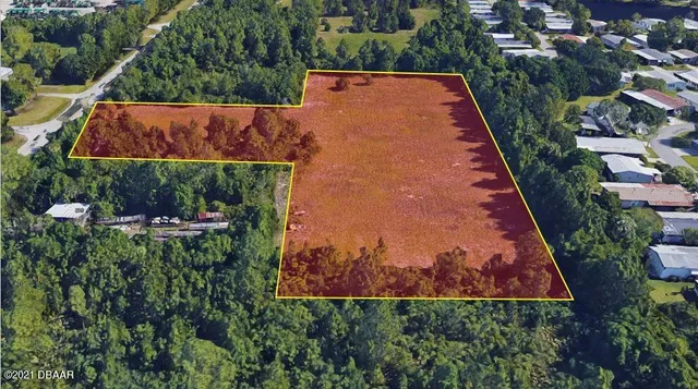 an aerial view of a house with swimming pool and outdoor space