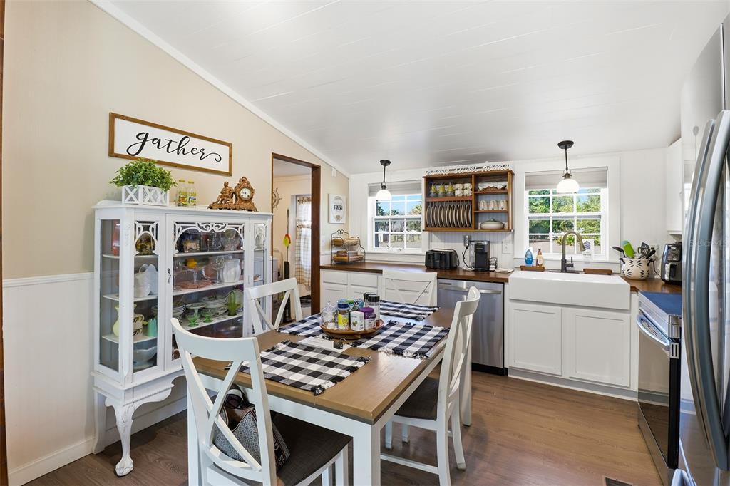 9510 North Eventide Point Crystal River, FL 34428 - Photo 2 of 45 a kitchen with stainless steel appliances a stove a refrigerator a dining table and chairs