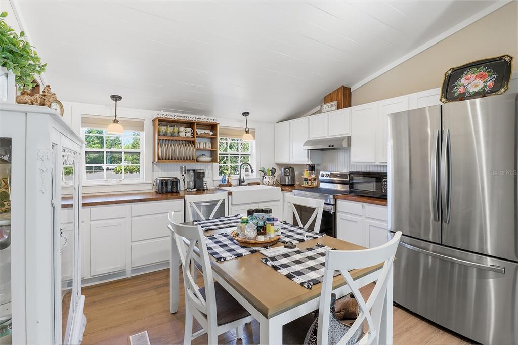 9510 North Eventide Point Crystal River, FL 34428 - Photo 25 of 45 a kitchen with stainless steel appliances a refrigerator a stove a sink and a dining table