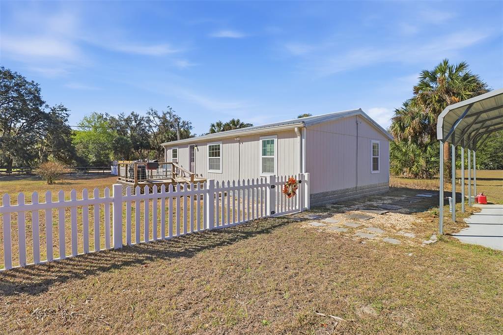 9510 North Eventide Point Crystal River, FL 34428 - Photo 7 of 45 a view of a house with a small yard and wooden fence