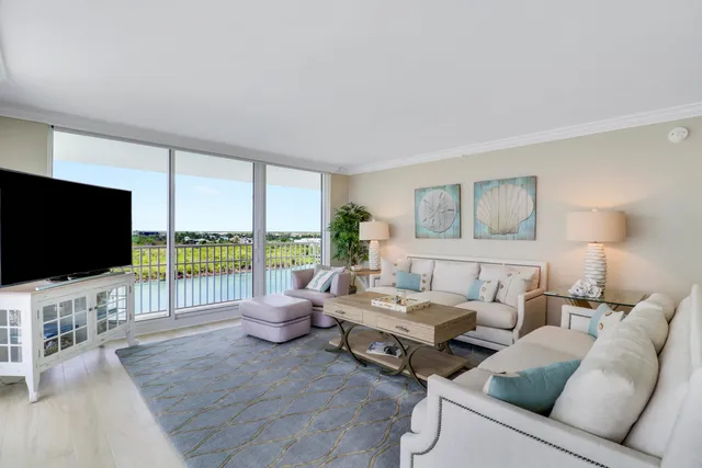 a living room with furniture and a painting on the wall
