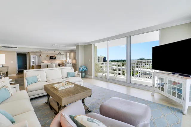 a view of a dining room with furniture potted plants and wooden floor