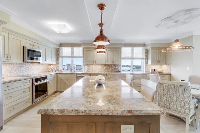 a living room with furniture a flat screen tv and a large window