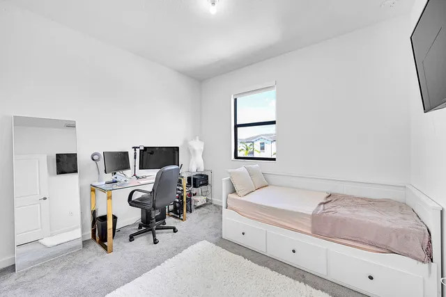 a bedroom with a bed and a flat screen tv