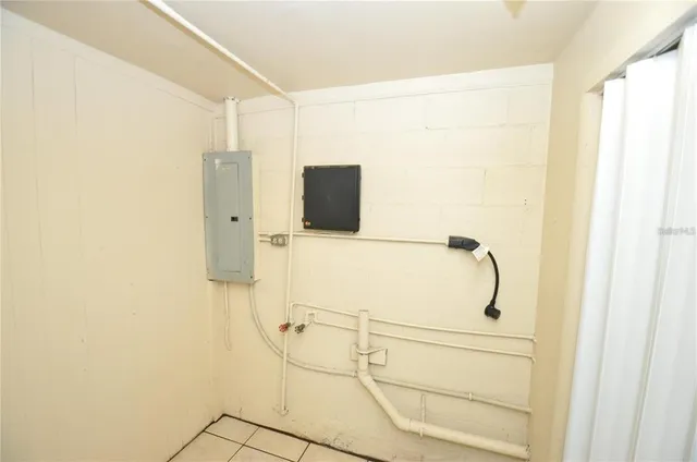 a view of a house with a yard and large trees