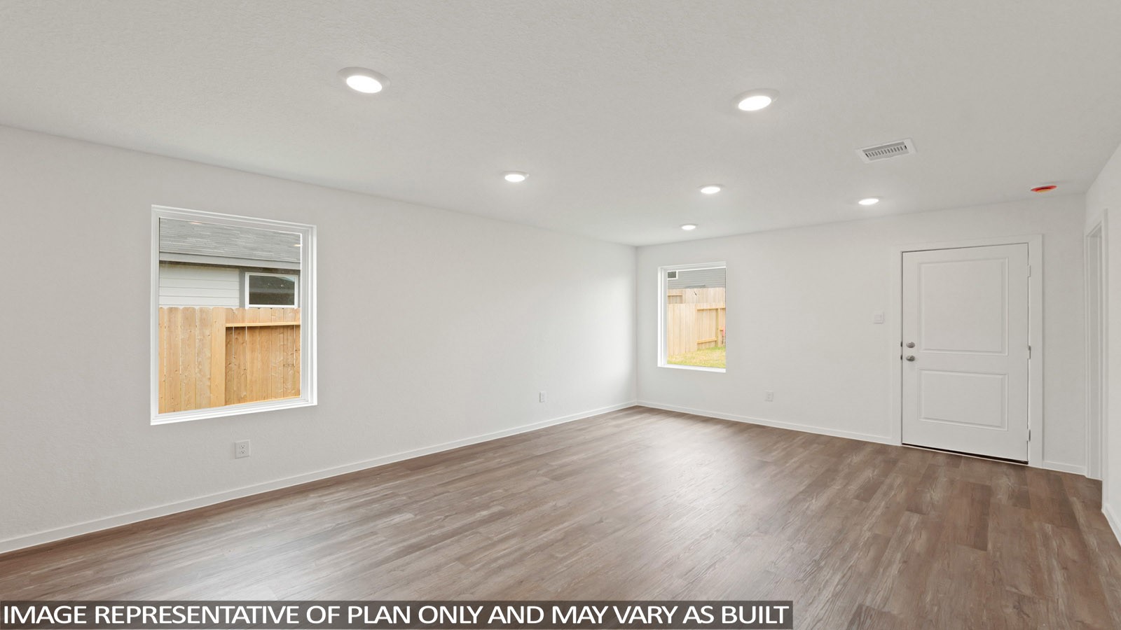 11707 Ruffian Drive Willis, TX 77318 - Photo 7 of 20 a view of an empty room with wooden floor and a window