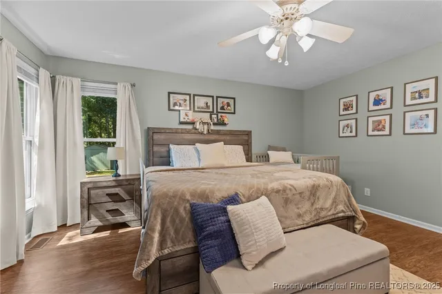 a bedroom with a large bed and a window