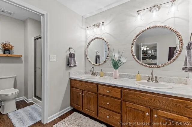 a bathroom with a double vanity sink and a mirror